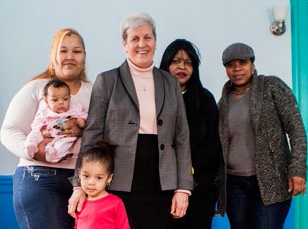 Sister Janet standing with residents of Providence House