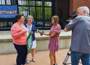 NETWORK organizer Sr. Eilis McColluh, HM, and Mary Nelson, justice-seekers in Erie PA speak to the media about the Care Not Cuts Rally in Erie, PA