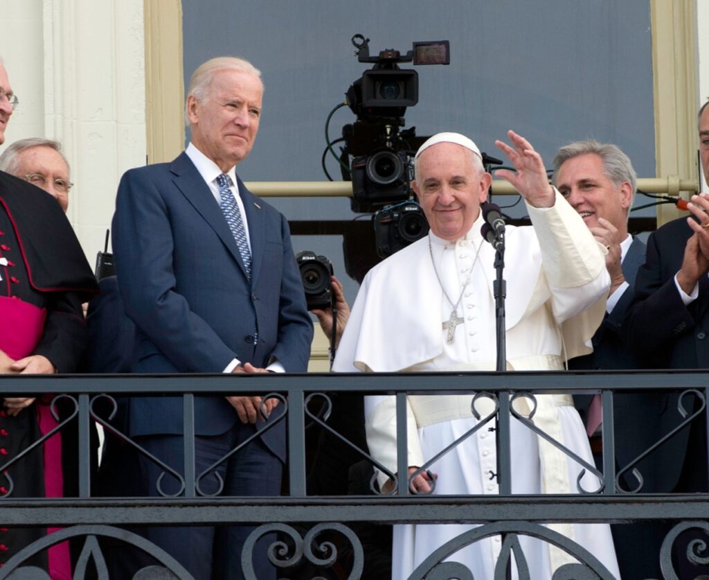 Pope Francis and Joe Biden stand on the balcony of the U.S. Capitol in 2015.